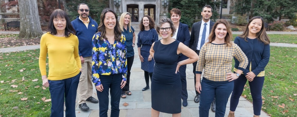 The Michigan Law Admissions team stands in the Law Quad. 