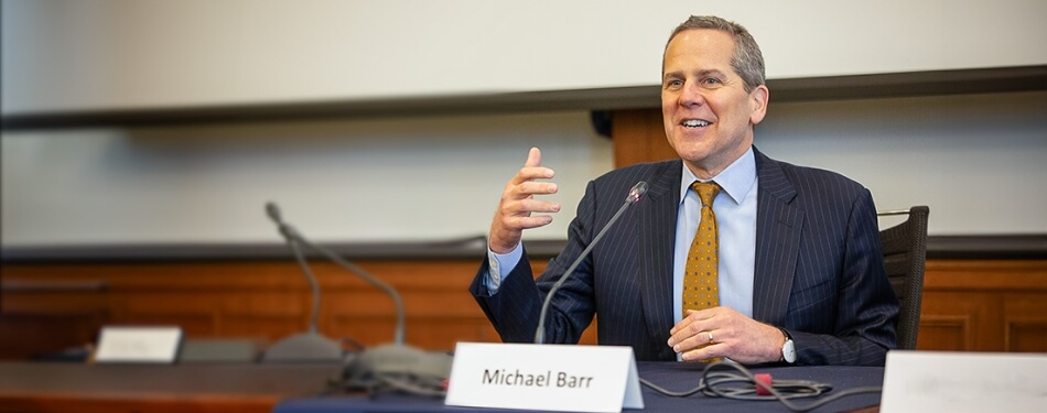 Michael Barr speaks in front of an audience at Michigan Law.