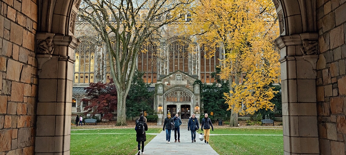 Students walking to and from class on the Quad during fall
