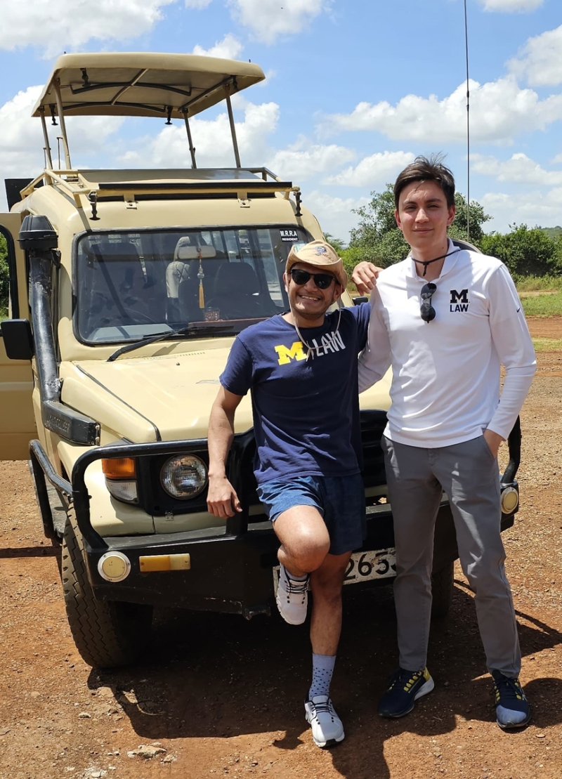 Two people standing in front of a jeep in Nairobi National Park.