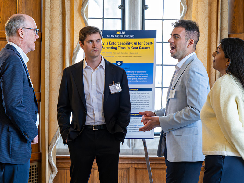 Judge T.J. Ackert speaking with Michigan Law student Karma Karira and team.