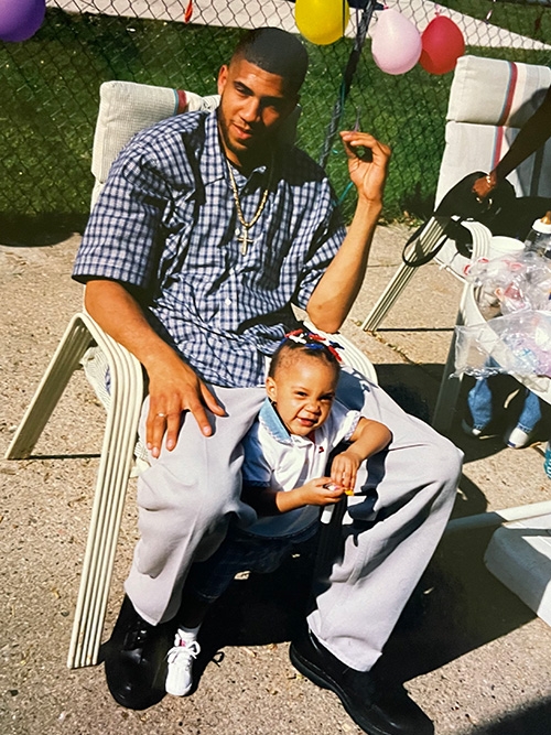 LaVone Hill sitting with his daughter on her first birthday.