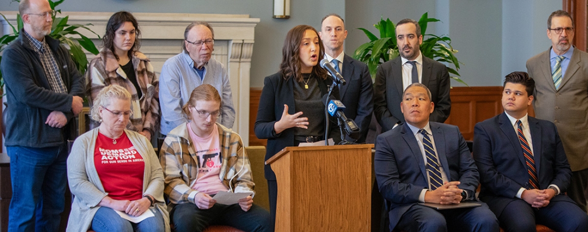 Michigan Law Student speaking from a podium at a press conference.