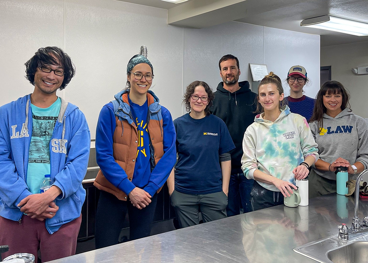 A group of Michigan Law alumni volunteering in a kitchen.