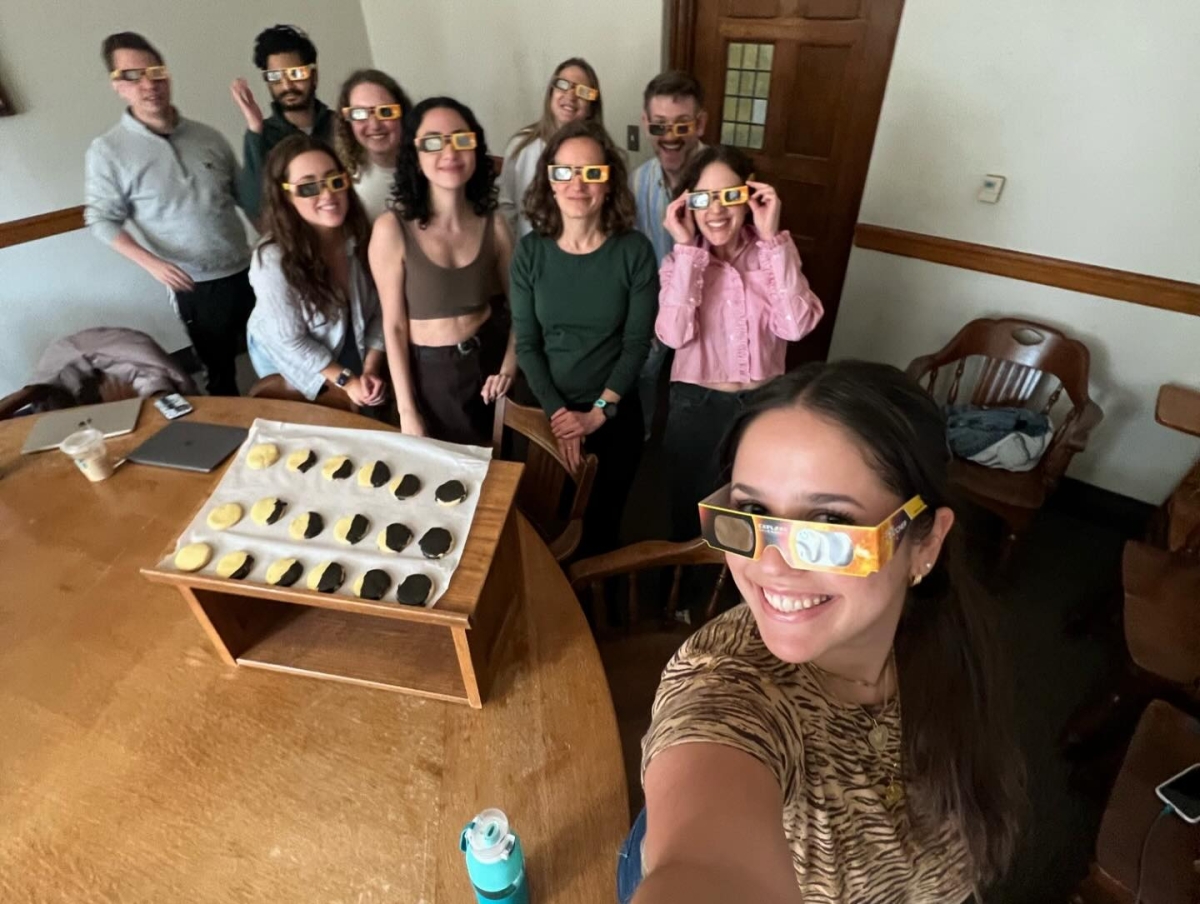 A selfie of the students in the PAC with Professors Mira Edmunds and Debra Chopp as well as a plate of homemade solar eclipse cookies.