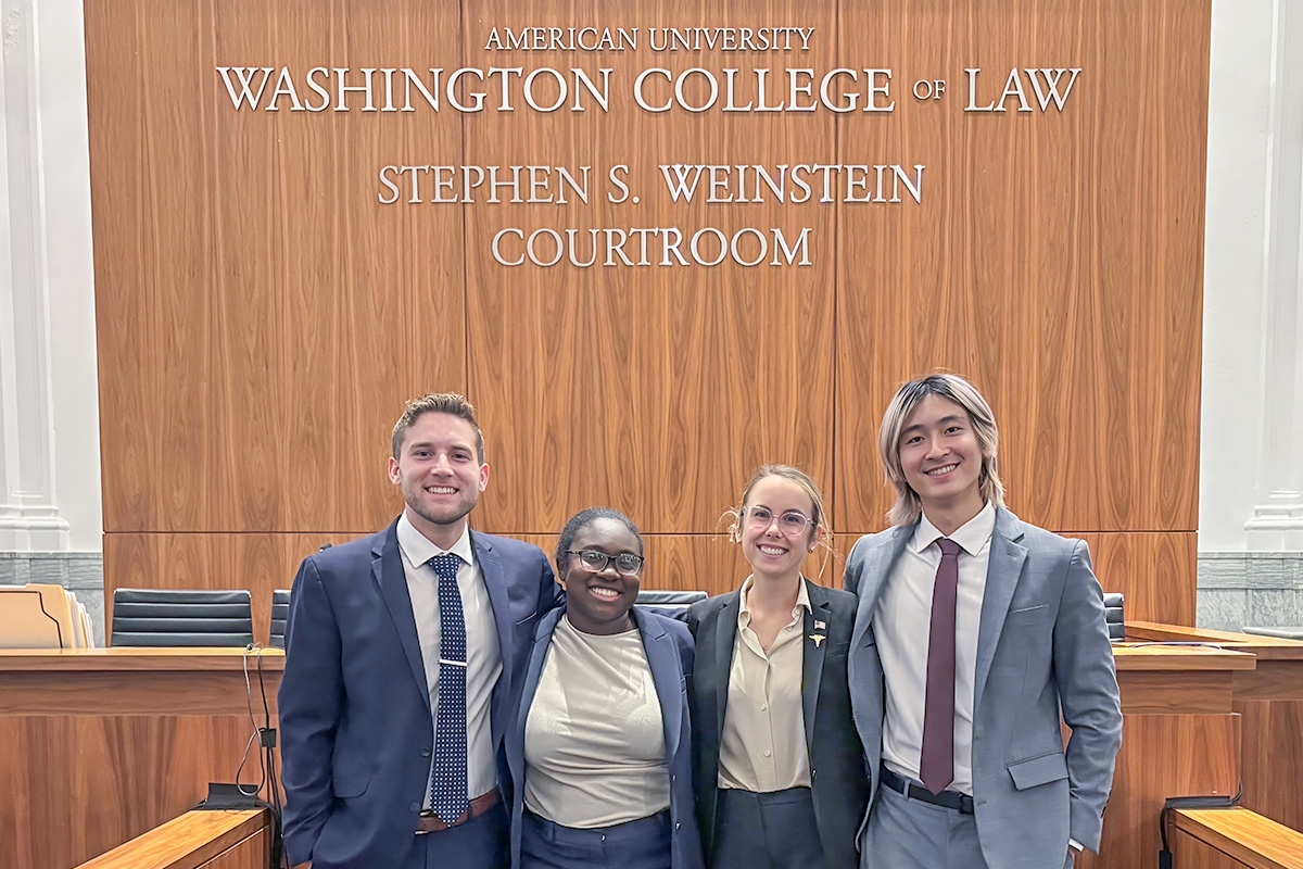 The Michigan Law Mock Trial Team from left to right, Nat Jordan, Joclyn Hutchison, Lauren Smith, and Brian Tang in the Washington College of Law Stephen S. Weinstein Courtroom.