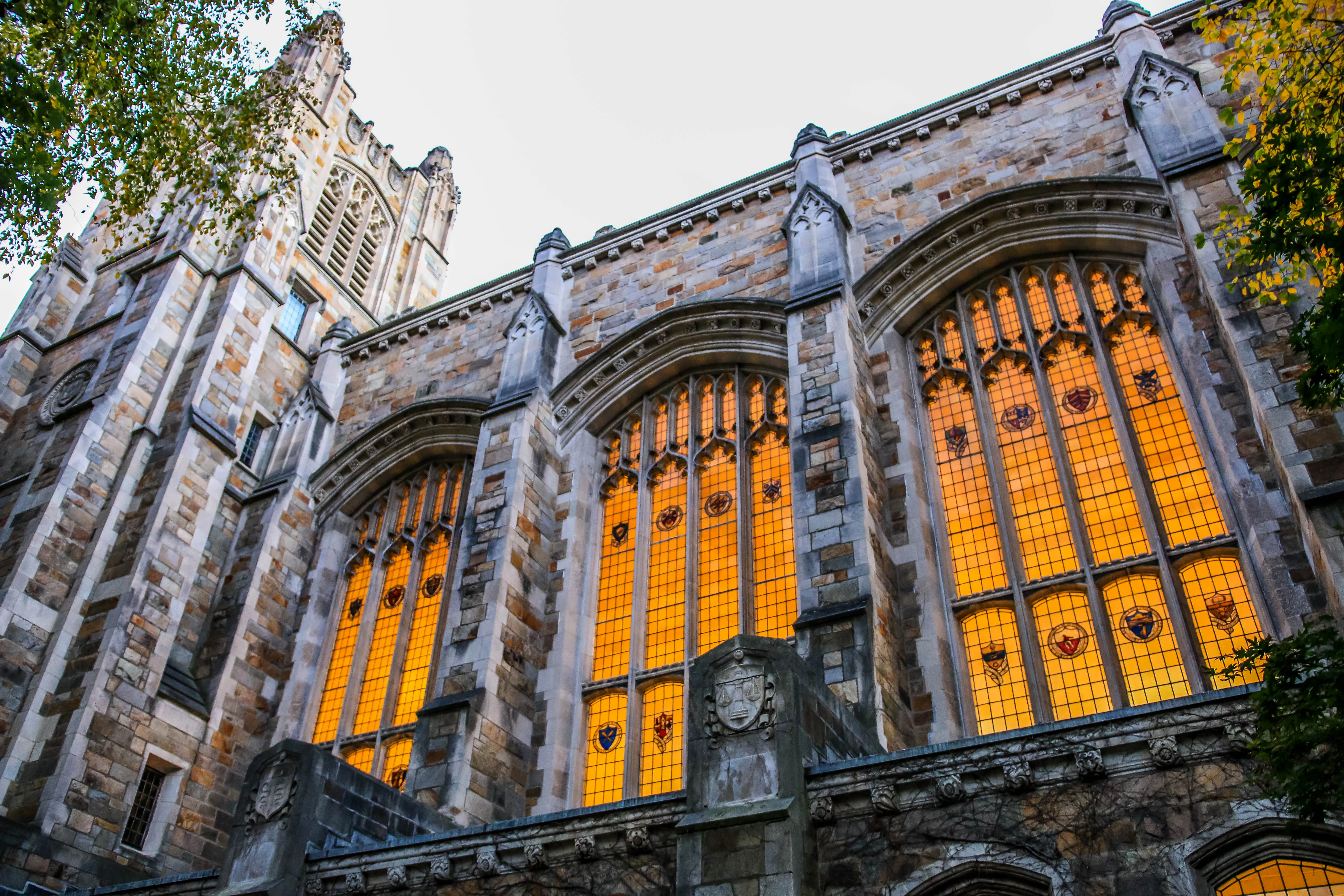 Exterior view of the Michigan Law Reading Room illuminated windows during dusk