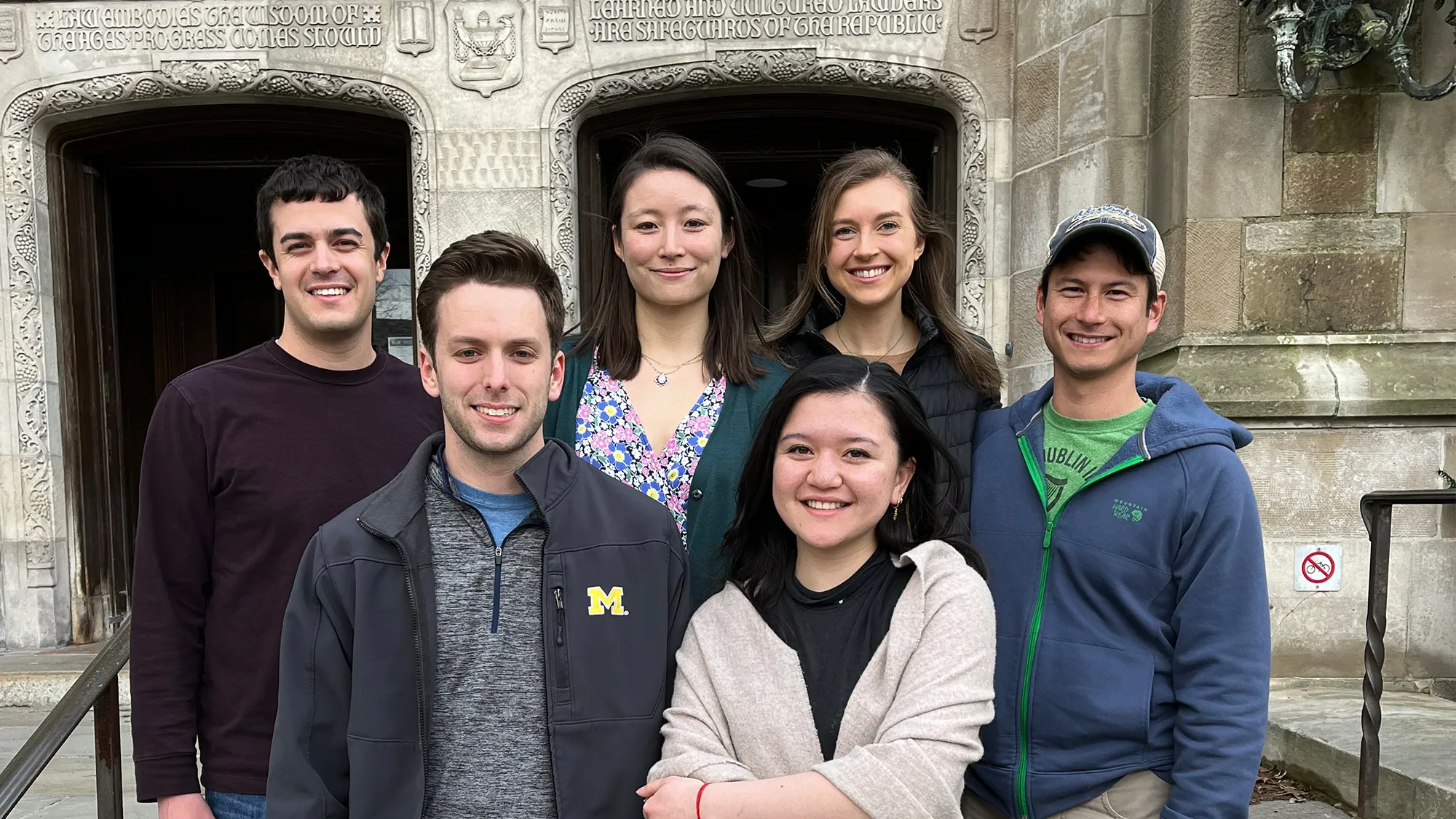 Six students standing in front of the law school after a Best-Ever Vis Moot Finish