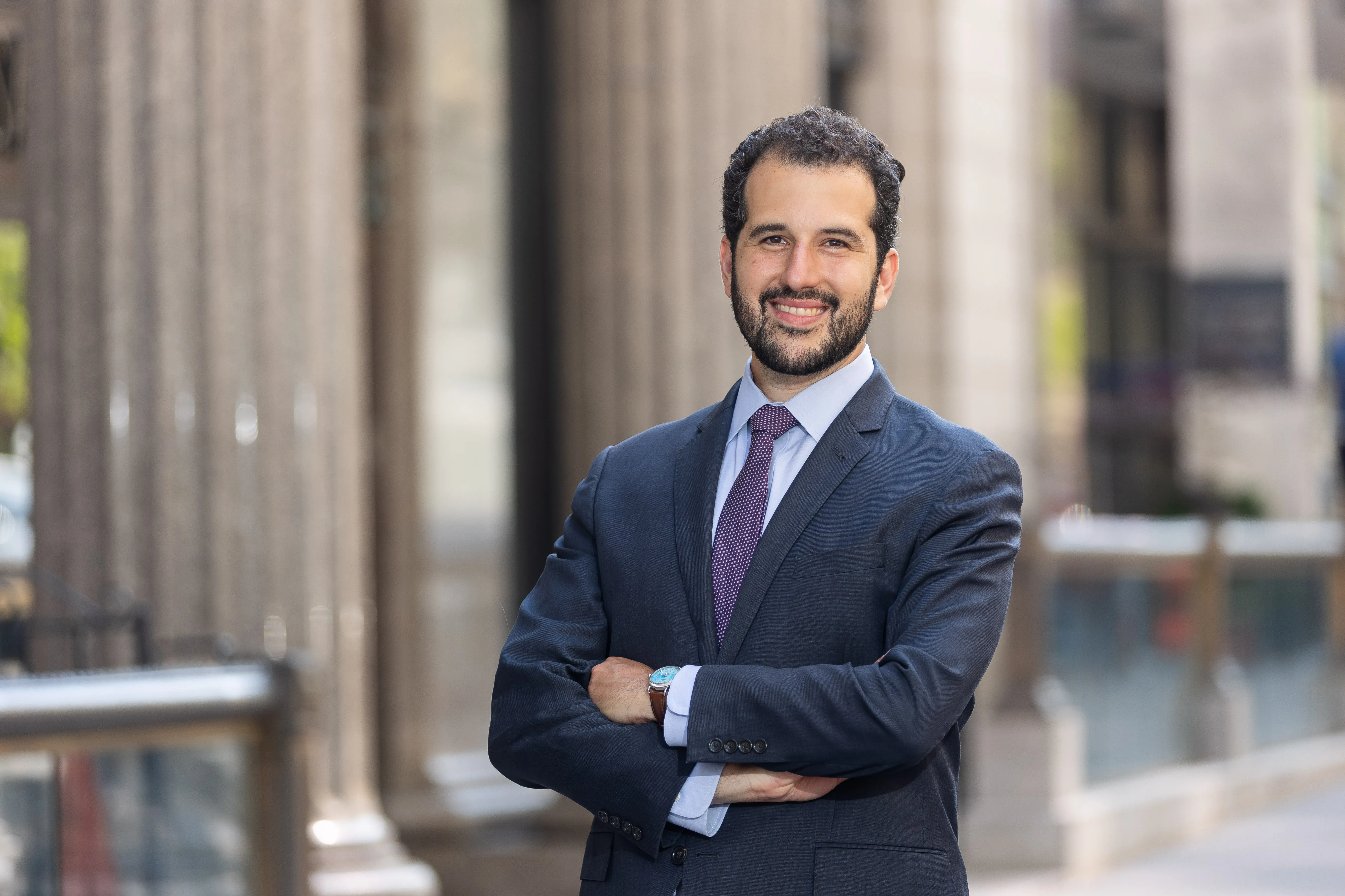 Professor Julian Arato standing in front of building columns