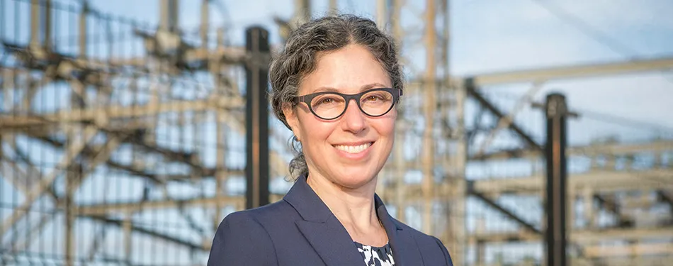 Professor Alexandra Klass standing in front of a hydroelectric facility 