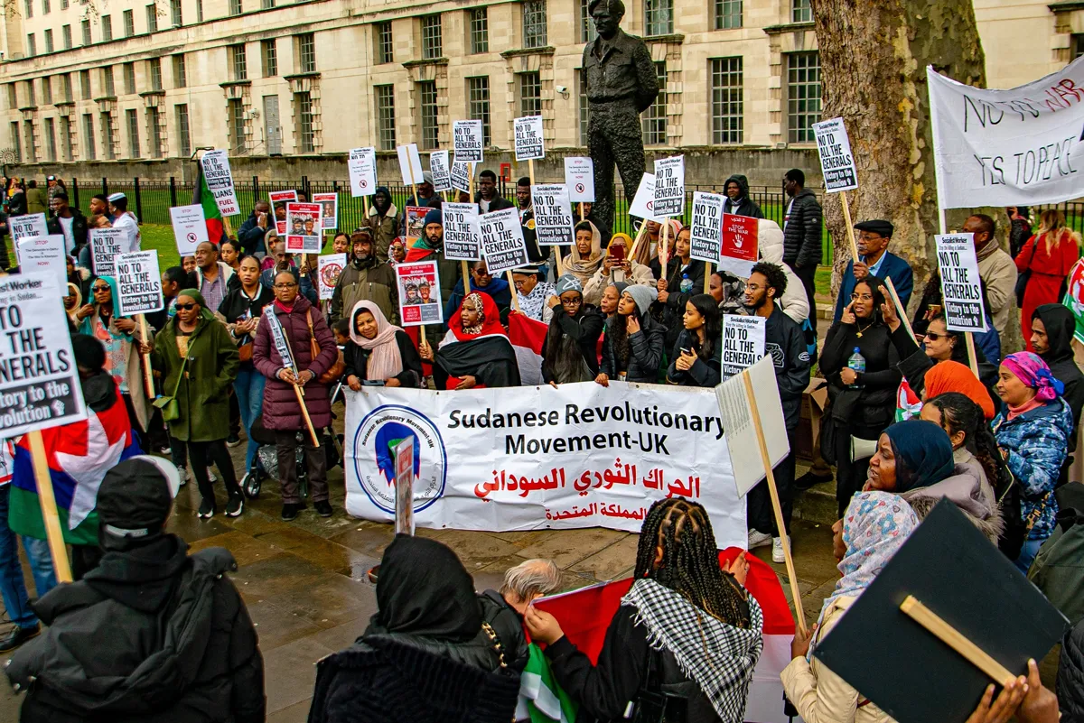 Protesters gather in London last month. Professor from Practice Susan Page argues that the international community can act to improve the situation in Sudan, by supporting relief efforts and pressuring neighboring governments. (Credit: Shutterstock/Zakariya Irfan)