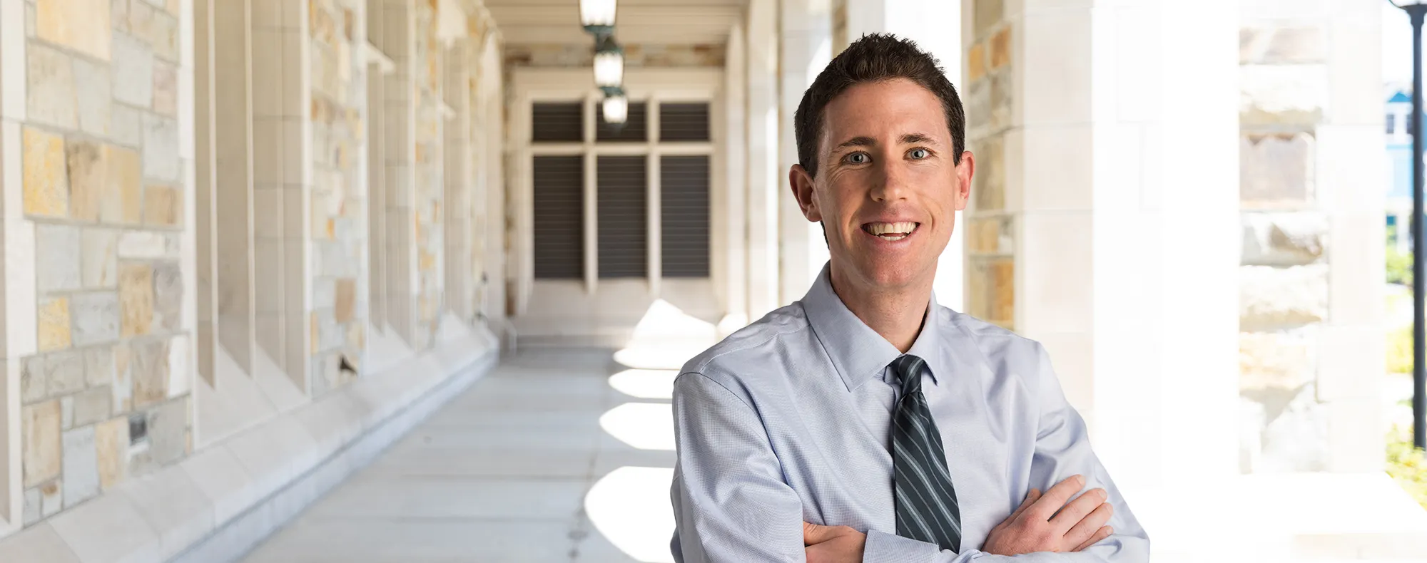 Patrick Barry standing under the cloisters at the UM  law school