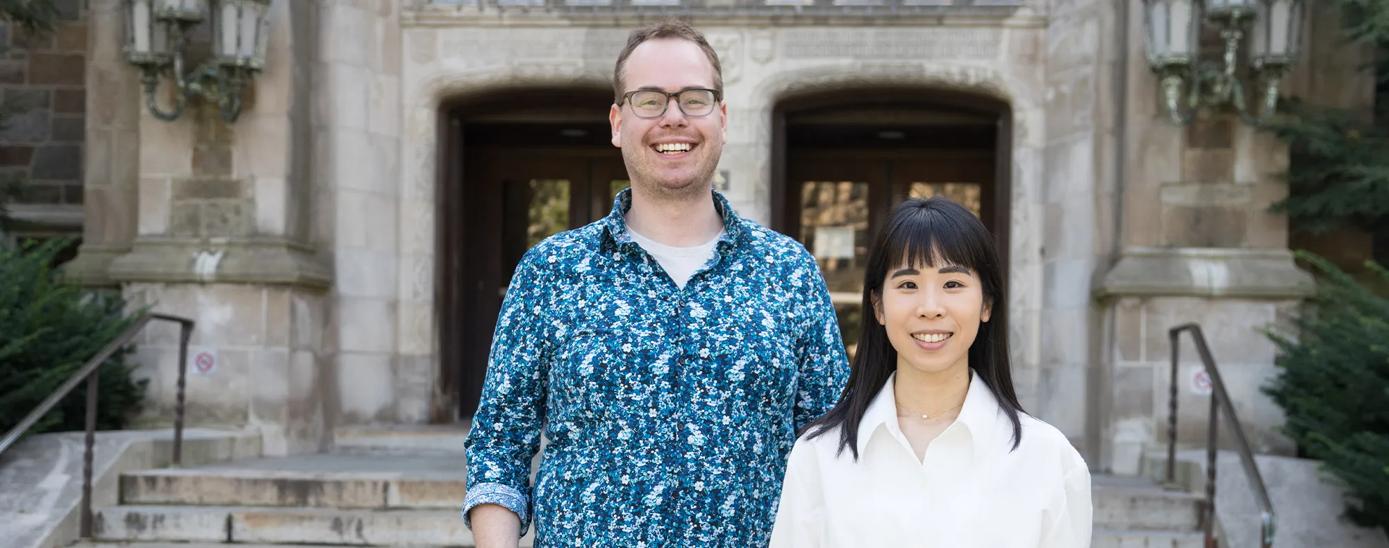 Two people standing in front of a building