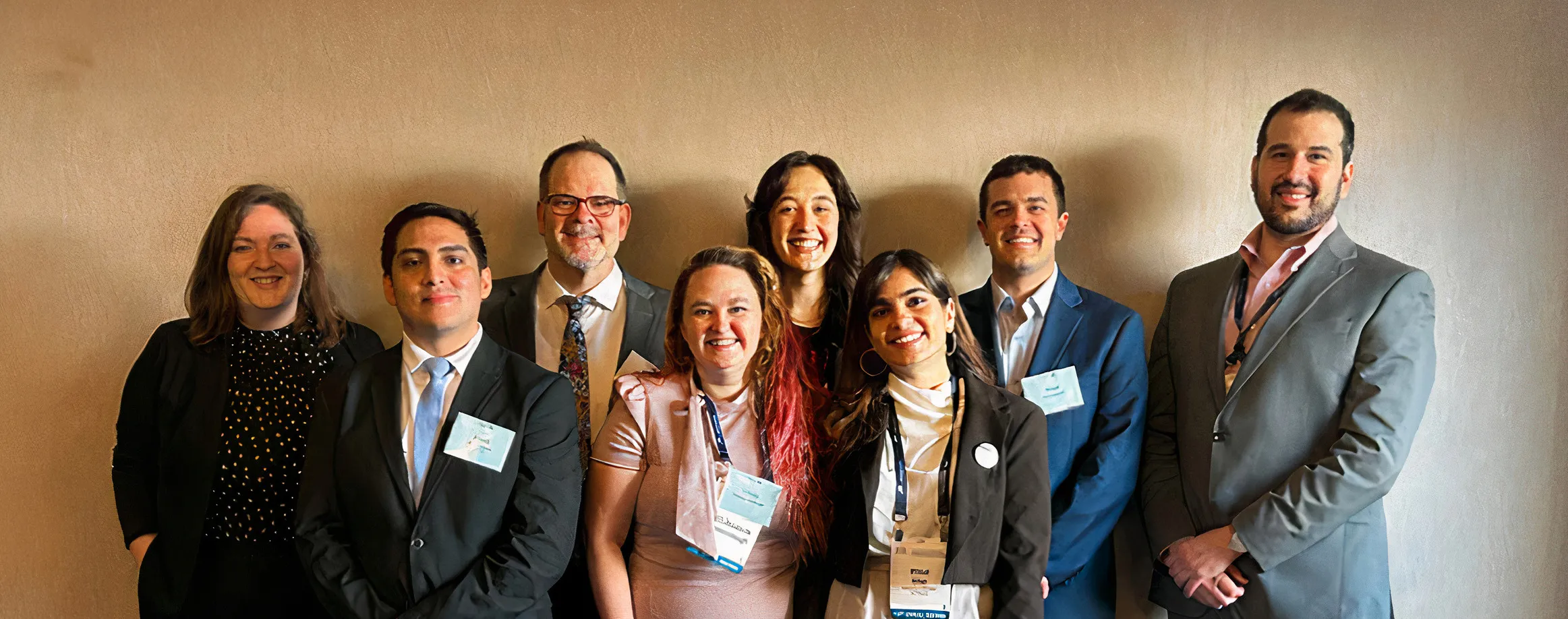 Group of professors and Michigan law school students smiling for a photo