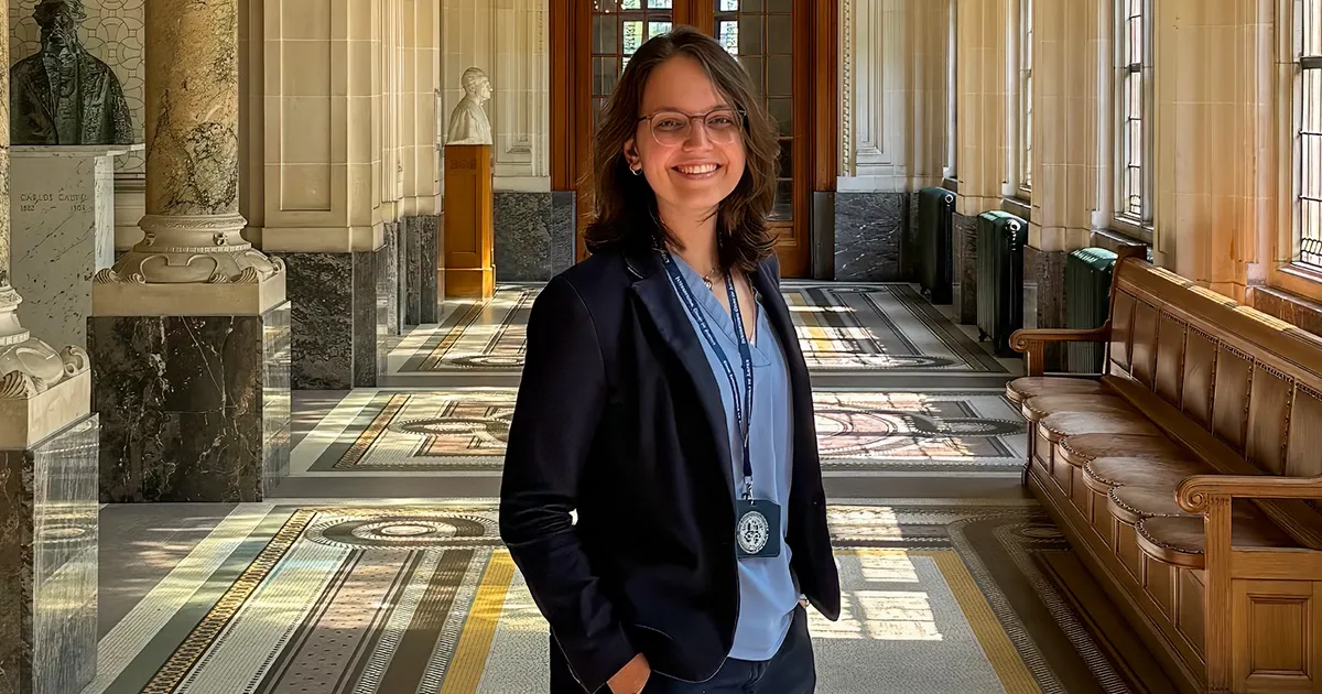 Mine Orer, LLM ’18 standing in the halls of the International Court of Justice.