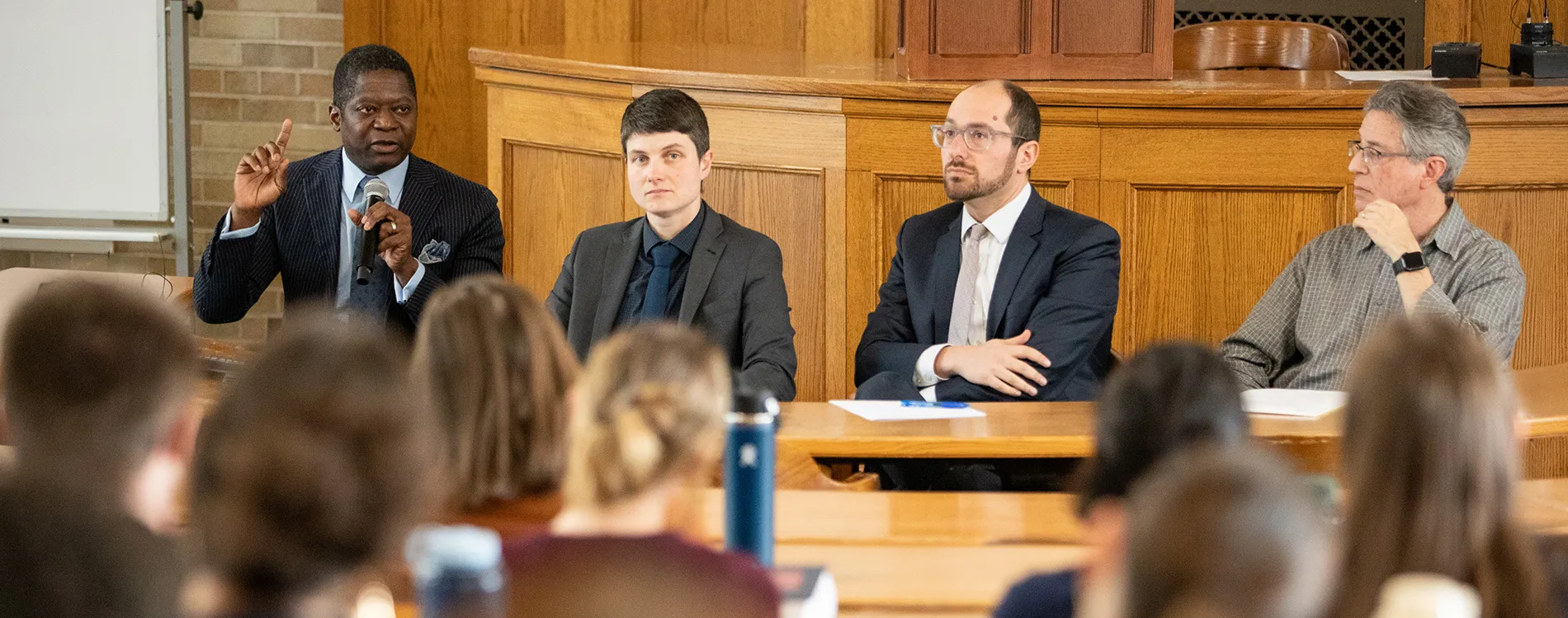 Michigan Law professors Ekow Yankah, Paulina Arnold, Noah Kazis, Evan Caminker speak at the Immigrant Enforcement Panel.