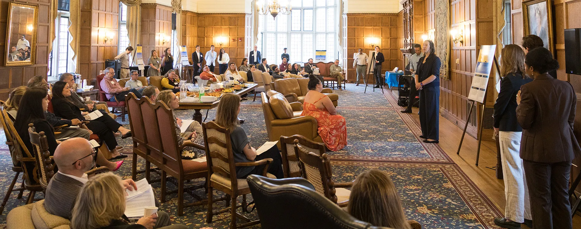 Bridgette Carr and Vivek Sankaran speak to an audience at the Michigan Law AI Showcase in the Lawyers Club Lounge.