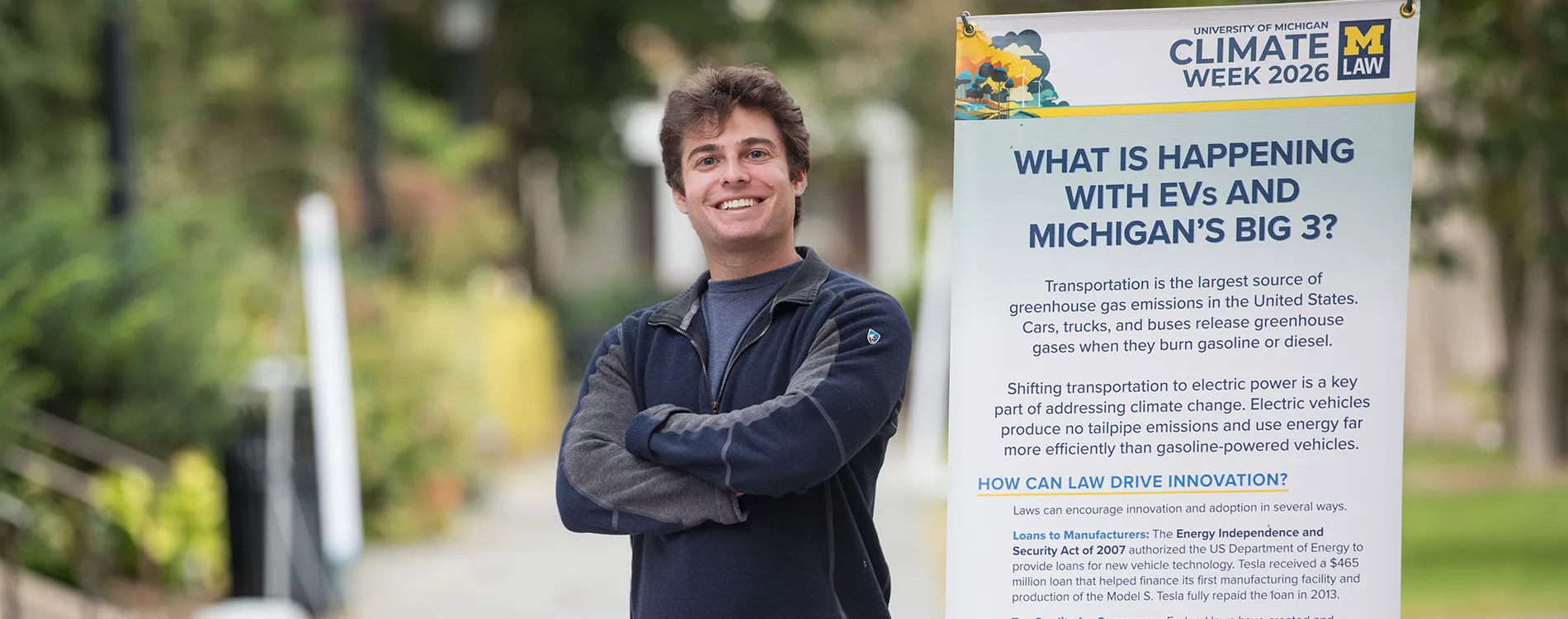 Ben Korn next to the Climate Week Exhibit in the Law Quad.