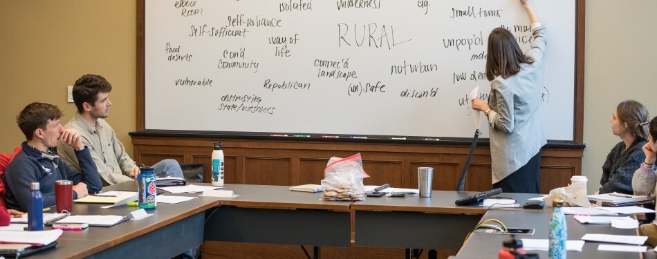 Emily Prifogle lectures in front of students in a classroom