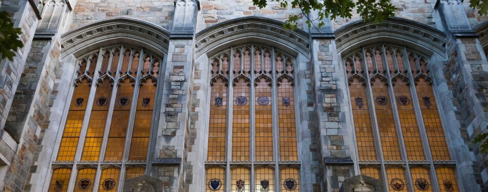 Exterior view of glowing reading room windows during summer