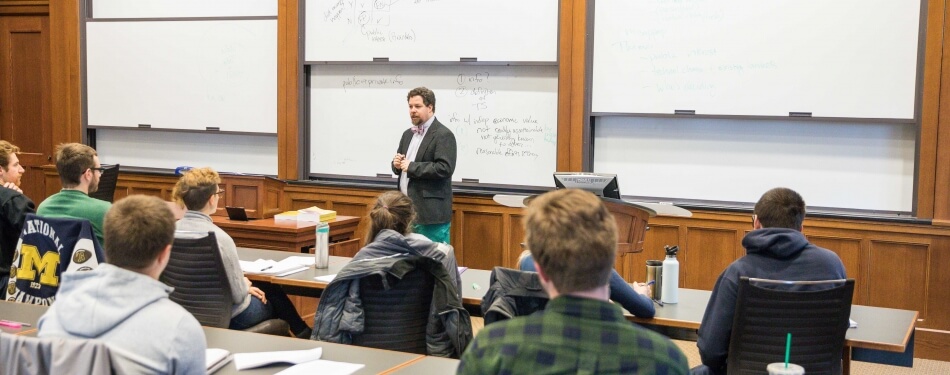 Nicholson Price lectures in front of a classroom full of students