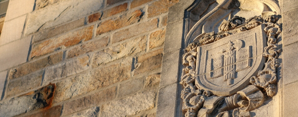 Crest detail on the stone law school.