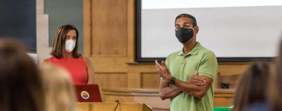 Bridgette Carr and Vivek Sankaran speak to students at the front of a classroom.