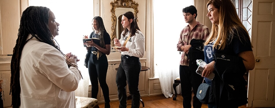 A group of students tours a plantation.