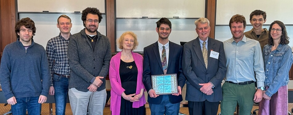 A group of people in a classroom at Michigan Law posing for a photo.