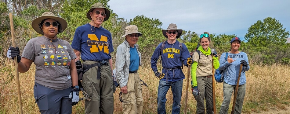 A group of Michigan Law alumni standing outside their volunteer site.