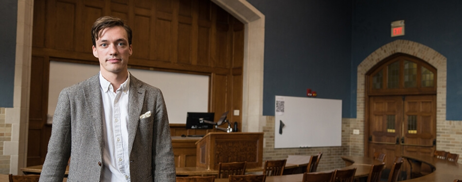 Philipp Krämer stands at the front of a Michigan Law classroom.