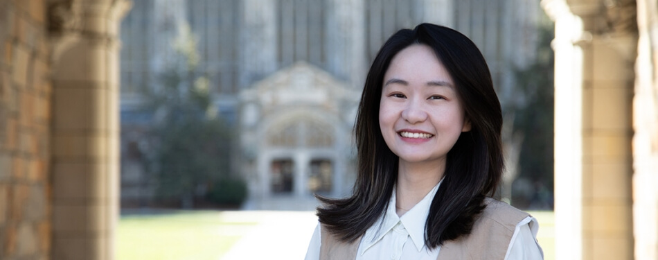 Xinyi Li smiles in the sunny Law Quad.