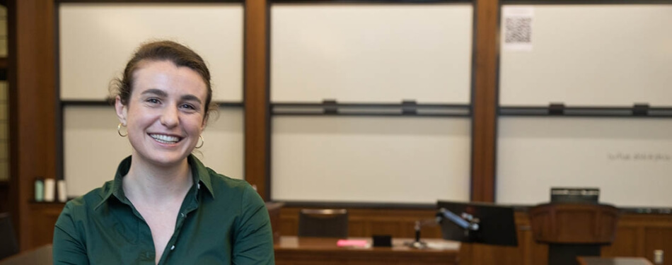 Nadia Sussman stands in front of a marker board in a Michigan Law classroom.