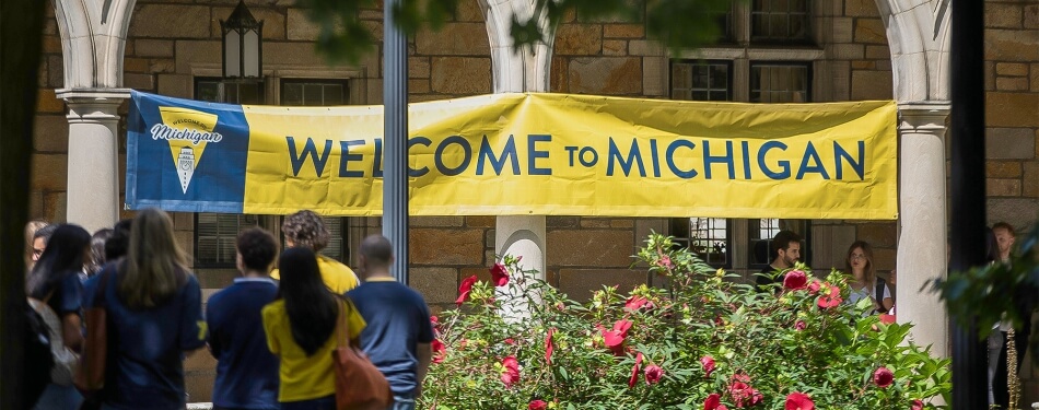 A "Welcome to Michigan" banner is hung outside the Lawyers Club, welcoming all who pass by.