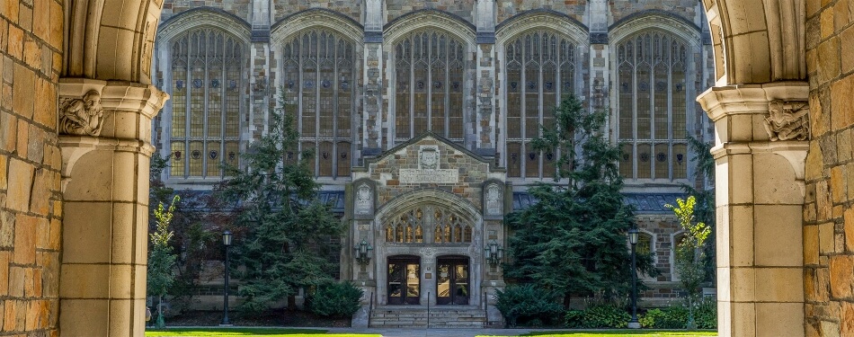 Exterior view of the Reading Room entrance from the Law Quad through a Lawyer's Club archway.