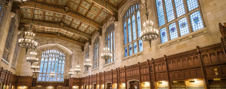 Interior of the Michigan Law Reading Room featuring the ornate lights and ceiling ornamentation.