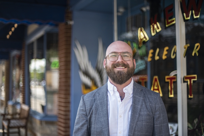 Professor Aaron Perzanowski with a tatto shop in the background