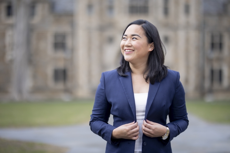 Paula Plaza tugs on her jacket while standing in the Michigan Law Quad.