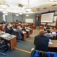 Attendees of the Transnational Law Symposium ask panelists questions.