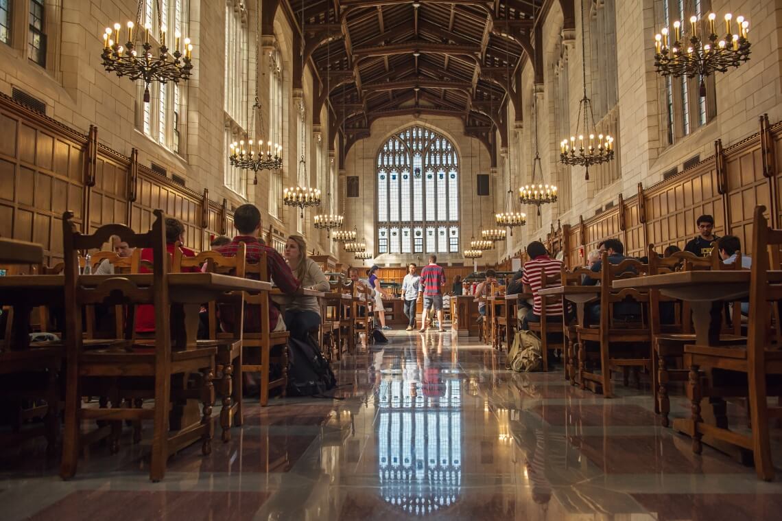 Interior view of the Law School Dining Hall with students gathered around tables sharing meals