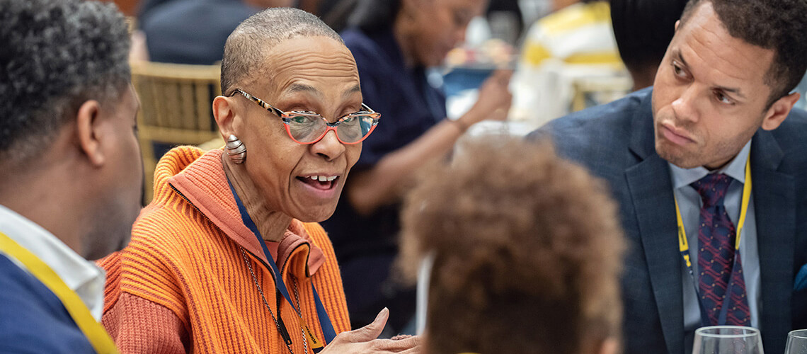 Michigan Law alumni reminisce during a reception in the Aikens Commons.