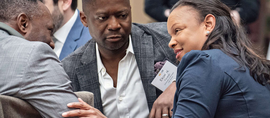 Ekow Yankah and Michigan Law alumni converse in Aikens Commons.