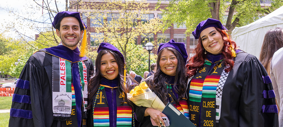 Four students pose after Senior Day ceremony.