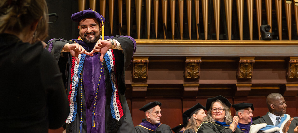 Michigan Law student makes an "M' gesture with their hands.