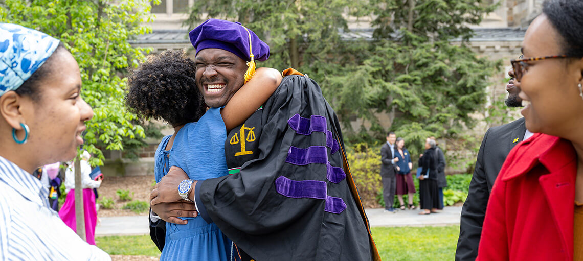 Michigan Law Student hugs family.