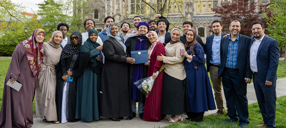 Michigan Law Student poses with their large group of family members.