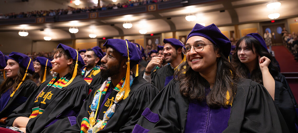 Michigan Law students smile at speaker during Senior Day.