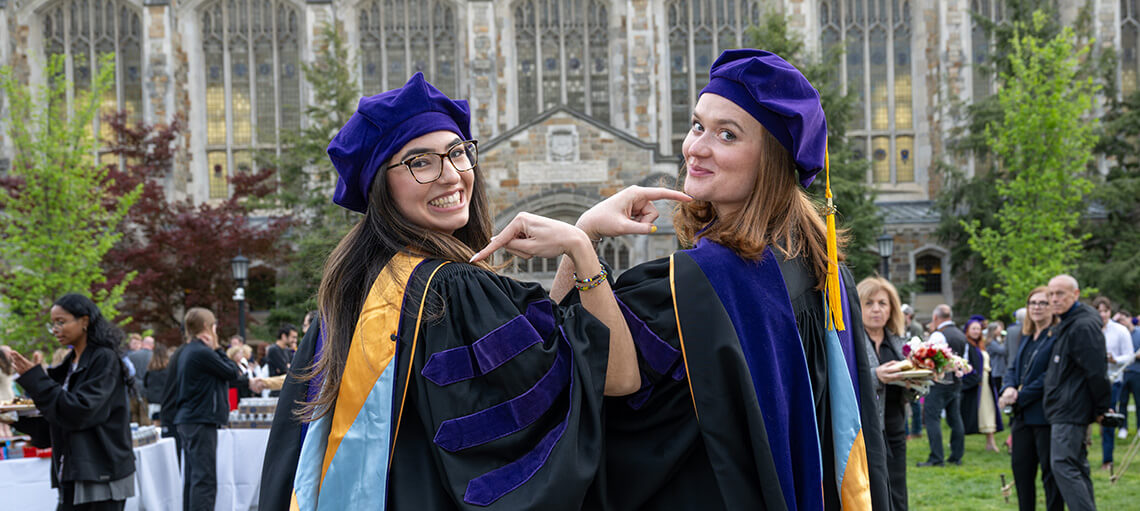 Michigan Law students pose and point to their shoulders.