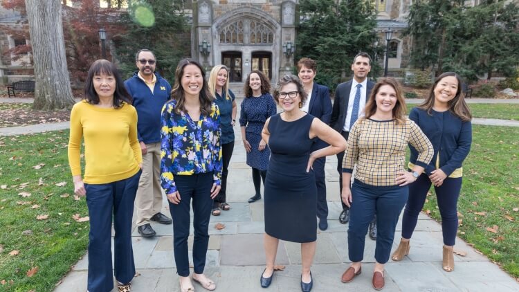 The Michigan Law Admissions team stands in the Law Quad. 