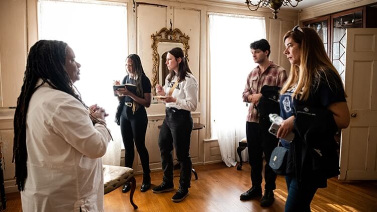 A group of students tours a plantation.